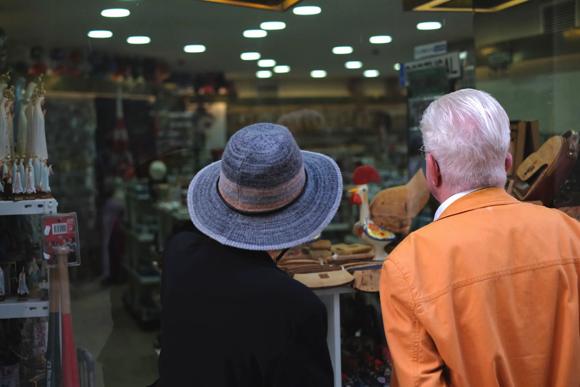 Tourists look at a shop window