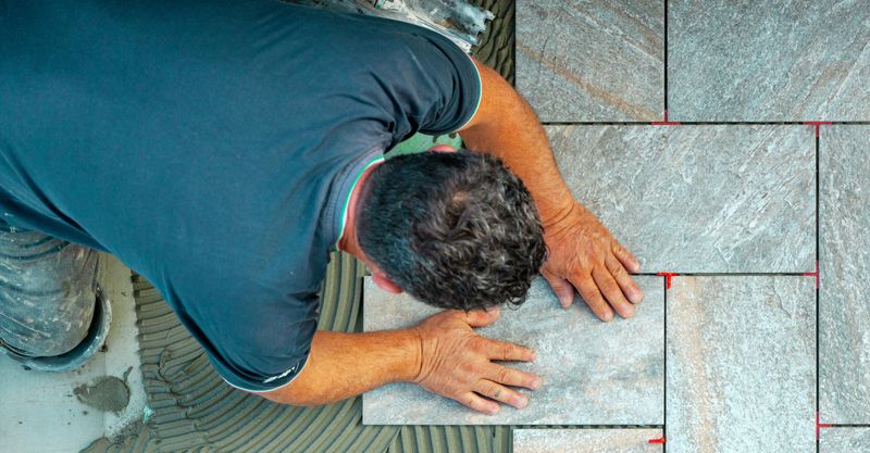 A tiler laying tiles