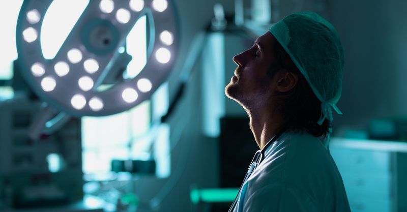 A doctor in the operating room takes a deep breath.