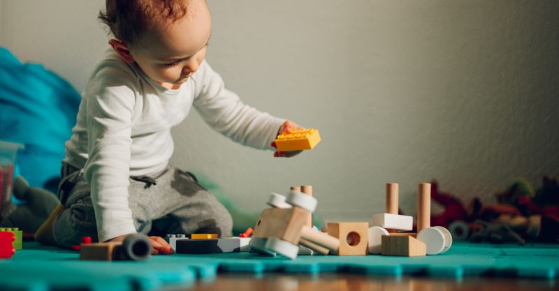 A child playing with bricks.